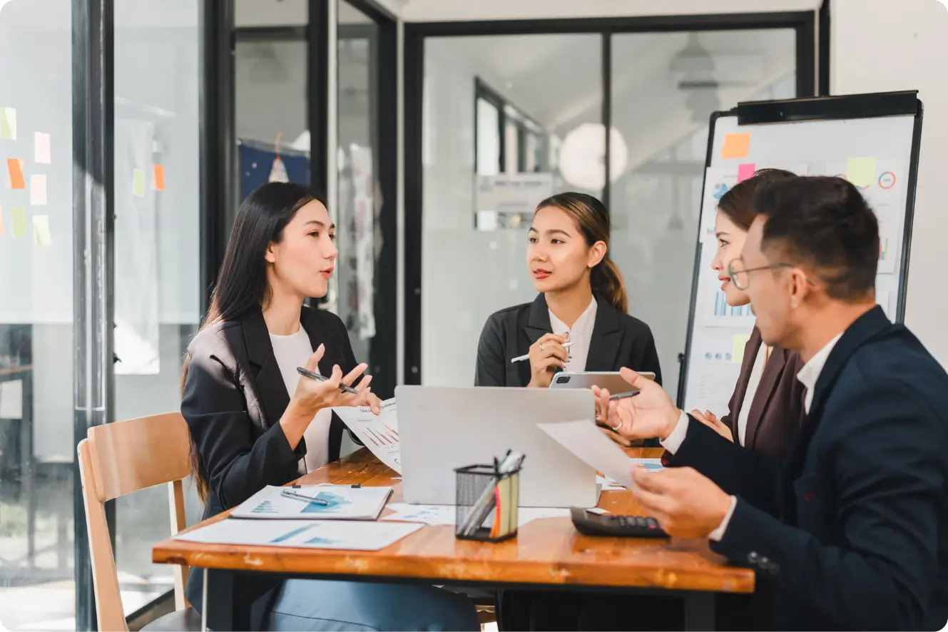 Four professionals debating financial reports